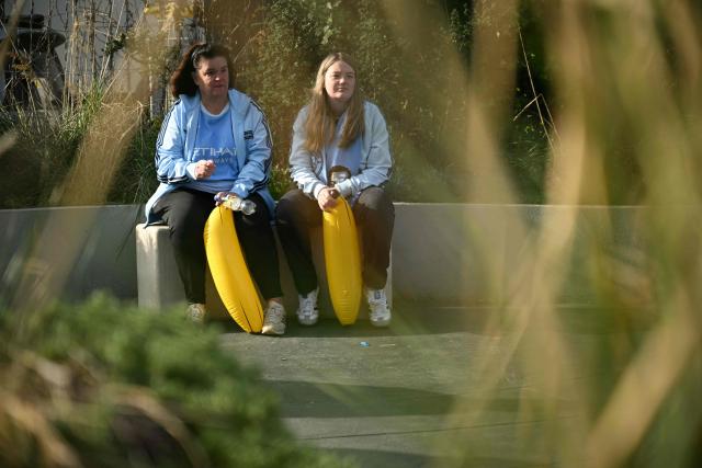 Two City fans wait with their inflatable bananas ahead of the English Premier League football match between Manchester City and Ipswich Town at the Etihad Stadium in Manchester, north west England, on October 17, 2026. (Photo by Oli SCARFF / AFP)