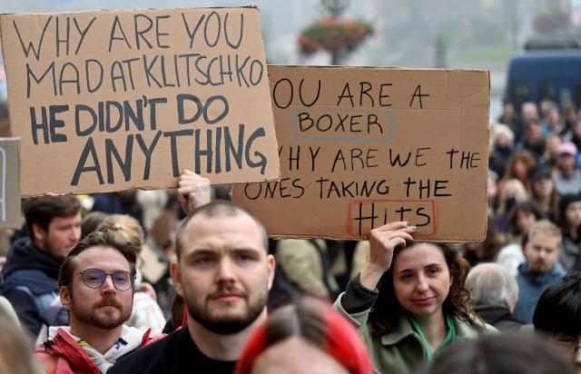 Activists hold placards and chant “Down with Klitschko” during a rally outside the town hall in Kyiv on October 17, 2026, calling for the resignation of Kyiv Mayor Vitali Klitschko, amid the Russian invasion of Ukraine. Representatives of various Ukraine public organisations declare systemic problems in Kyiv's administration over the last 12 years of Klitschko's tenure and the capital's lack of readiness for winter amid mass Russia shelling. (Photo by Sergei SUPINSKY / AFP)