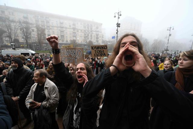 Activists hold placards and chant “Down with Klitschko” during a rally outside the town hall in Kyiv on October 17, 2026, calling for the resignation of Kyiv Mayor Vitali Klitschko, amid the Russian invasion of Ukraine. Representatives of various Ukraine public organisations declare systemic problems in Kyiv's administration over the last 12 years of Klitschko's tenure and the capital's lack of readiness for winter amid mass Russia shelling. (Photo by Sergei SUPINSKY / AFP)