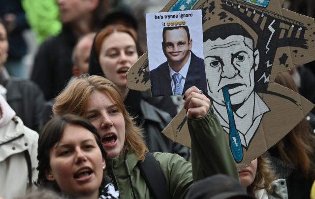 Activists hold placards and chant “Down with Klitschko” during a rally outside the town hall in Kyiv on October 17, 2026, calling for the resignation of Kyiv Mayor Vitali Klitschko, amid the Russian invasion of Ukraine. Representatives of various Ukraine public organisations declare systemic problems in Kyiv's administration over the last 12 years of Klitschko's tenure and the capital's lack of readiness for winter amid mass Russia shelling. (Photo by Sergei SUPINSKY / AFP)