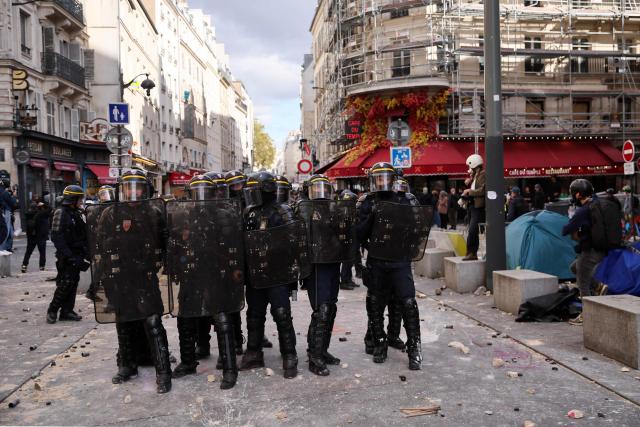 French Republican Security Corps (CRS - Compagnies Republicaines de Securite) officers stand gard during a demonstration to protest against the "high cost of living", at Place de la Republique in Paris on October 17, 2026 as part of a nationwide call for mobilisation bringing together various groups expressing their anger: former "Yellow Vests", secondary school and university students, climate activists and even farmers. After weeks of student protests, France faces broader, nationwide demonstrations on October 17, 2026 over the cost of living, setting up a potentially fraught six months heading into a presidential election. A police source told AFP that authorities estimated nearly 200,000 people could take part, with 40,000 in Paris. (Photo by Kiran RIDLEY / AFP)