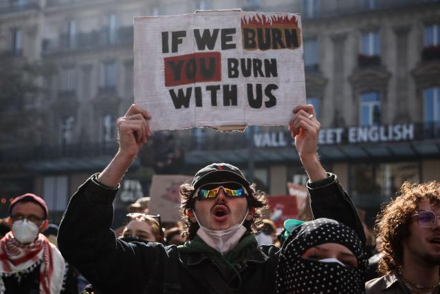 A protesters holds a placard during a demonstration to protest against the "high cost of living", at Place de la Republique in Paris on October 17, 2026 as part of a nationwide call for mobilisation bringing together various groups expressing their anger: former "Yellow Vests", secondary school and university students, climate activists and even farmers. After weeks of student protests, France faces broader, nationwide demonstrations on October 17, 2026 over the cost of living, setting up a potentially fraught six months heading into a presidential election. A police source told AFP that authorities estimated nearly 200,000 people could take part, with 40,000 in Paris. (Photo by Kiran RIDLEY / AFP)
