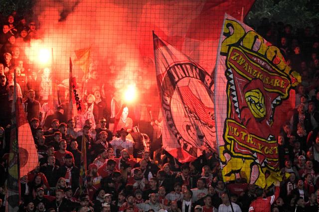 Union Berlin fans light flares during the German first division Bundesliga football match between Union Berlin and Borussia Dortmund in Berlin on October 17, 2026. (Photo by John MACDOUGALL / AFP) / DFL REGULATIONS PROHIBIT ANY USE OF PHOTOGRAPHS AS IMAGE SEQUENCES AND/OR QUASI-VIDEO