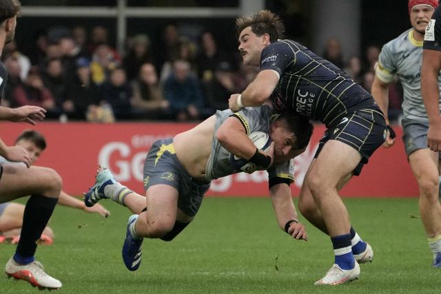 Leinster’s Irish hooker Dan Sheehan (C) is tackled during the European Rugby Champions Cup rugby union match between ASM Clermont Auvergne and Leinster Rugby at at the Marcel-Michelin stadium in Clermont-Ferrand, central France, on October 17, 2026. (Photo by Idriss Bigou-Gilles / AFP)