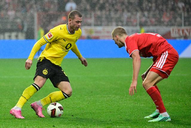 Dortmund's Norwegian defender #26 Julian Ryerson (L) and Union Berlin's German defender #15 Tom Rothe vie for the ball during the German first division Bundesliga football match between Union Berlin and Borussia Dortmund in Berlin on October 17, 2026. (Photo by John MACDOUGALL / AFP) / DFL REGULATIONS PROHIBIT ANY USE OF PHOTOGRAPHS AS IMAGE SEQUENCES AND/OR QUASI-VIDEO