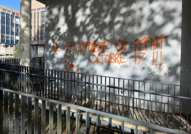 This general view shows graffiti 'October 17-we're doing it again' which is linked to nationwide demonstrations, adorning a building at the University of Rouen at Mont-Saint-Aignan on the outskirts of Rouen, north-western France on October 17, 2026, following a suspected act of arson at the establishment. A criminal investigation has started into the fire that severely damaged a building of the Faculty of Arts in Rouen, in Mont-Saint-Aignan (Seine-Maritime), early October 17. According to the initial findings, the fire started from a pile of rubbish or a garbage bin in front of the entrance to the building, according to a source close to the case and the public prosecutor of Rouen, Sébastien Gallois. (Photo by Manuel SANSON / AFP)