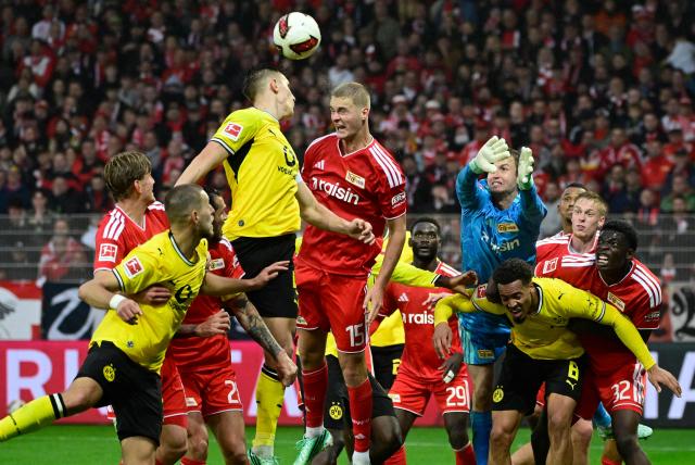 Players of Dortmund (yellow) and Union Berlin (red) vie for the ball during the German first division Bundesliga football match between Union Berlin and Borussia Dortmund in Berlin on October 17, 2026. (Photo by John MACDOUGALL / AFP) / DFL REGULATIONS PROHIBIT ANY USE OF PHOTOGRAPHS AS IMAGE SEQUENCES AND/OR QUASI-VIDEO