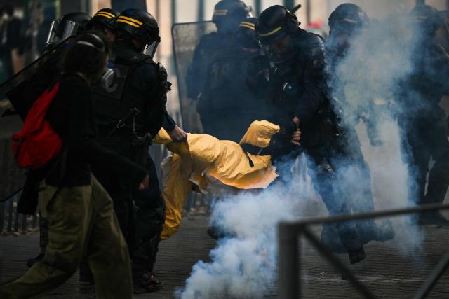 French Republican Security Corps (CRS - Compagnies Republicaines de Securite) detain a protestor during a demonstration to protest against the "high cost of living", in Bordeaux, southwestern France, on October 17, 2026 as part of a nationwide call for mobilisation bringing together various groups expressing their anger: former "Yellow Vest", secondary school and university students, climate activists and even farmers. After weeks of student protests, France faces broader, nationwide demonstrations on October 17, 2026 over the cost of living, setting up a potentially fraught six months heading into a presidential election. A police source told AFP that authorities estimated nearly 200,000 people could take part, with 40,000 in Paris. (Photo by Christophe ARCHAMBAULT / AFP)