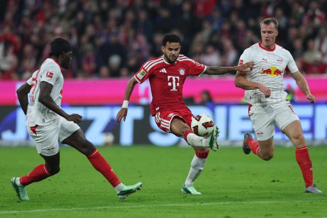 Bayern Munich's Colombian forward #14 Luis Diaz (C), Leipzig's French defender #23 Castello Lukeba (L) and Leipzig's German defender #16 Lukas Klostermann vie for the ball during the German first division Bundesliga football match between FC Bayern Munich and RB Leipzig in Munich, southern Germany, on October 17, 2026. (Photo by Alexandra BEIER / AFP) / DFL REGULATIONS PROHIBIT ANY USE OF PHOTOGRAPHS AS IMAGE SEQUENCES AND/OR QUASI-VIDEO