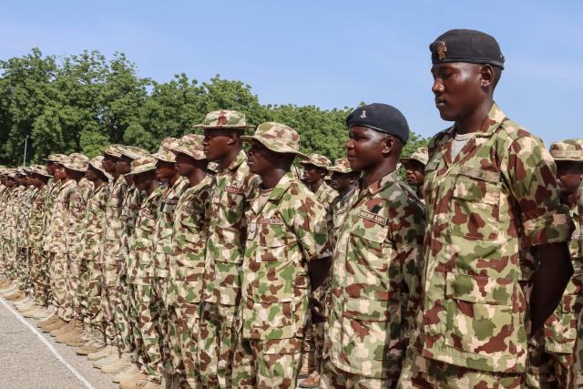Nigerian Army personnel stand at attention during the vist of Nigeria's Chief of Army Staff (COAS) Lieutenant General Waidi Shaibu to the Headquarters Theatre Command Joint Task Force in Maiduguri, on October 17, 2026. Suspected jihadists believed to be linked to the Islamic State (IS) group killed 15 soldiers and five members of anti-jihadist militias in an attack on a base in Borno State, in northeastern Nigeria, military and local sources said on October 14. "The terrorists killed 15 soldiers and five members of the CJTF militia who were assisting the soldiers in the attack," a Nigerian army officer told AFP. (Photo by Audu MARTE / AFP)