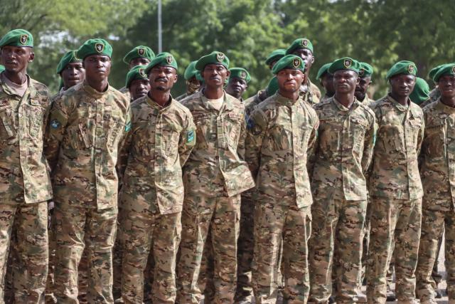 Nigerian Army personnel stand at attention during the vist of Nigeria's Chief of Army Staff (COAS) Lieutenant General Waidi Shaibu to the Headquarters Theatre Command Joint Task Force in Maiduguri, on October 17, 2026. Suspected jihadists believed to be linked to the Islamic State (IS) group killed 15 soldiers and five members of anti-jihadist militias in an attack on a base in Borno State, in northeastern Nigeria, military and local sources said on October 14. "The terrorists killed 15 soldiers and five members of the CJTF militia who were assisting the soldiers in the attack," a Nigerian army officer told AFP. (Photo by Audu MARTE / AFP)