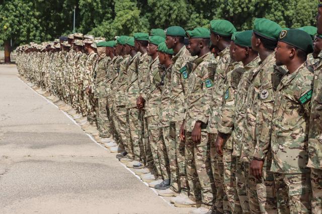 Nigerian Army personnel stand at attention during the vist of Nigeria's Chief of Army Staff (COAS) Lieutenant General Waidi Shaibu to the Headquarters Theatre Command Joint Task Force in Maiduguri, on October 17, 2026. Suspected jihadists believed to be linked to the Islamic State (IS) group killed 15 soldiers and five members of anti-jihadist militias in an attack on a base in Borno State, in northeastern Nigeria, military and local sources said on October 14. "The terrorists killed 15 soldiers and five members of the CJTF militia who were assisting the soldiers in the attack," a Nigerian army officer told AFP. (Photo by Audu MARTE / AFP)