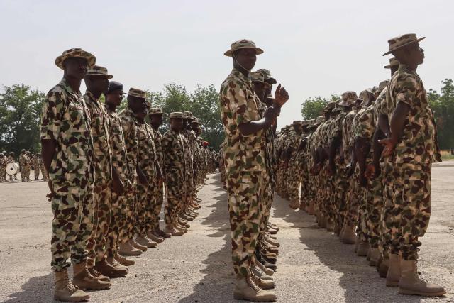 TOPSHOT - Nigerian Army personnel stand at attention during the vist of Nigeria's Chief of Army Staff (COAS) Lieutenant General Waidi Shaibu to the Headquarters Theatre Command Joint Task Force in Maiduguri, on October 17, 2026. Suspected jihadists believed to be linked to the Islamic State (IS) group killed 15 soldiers and five members of anti-jihadist militias in an attack on a base in Borno State, in northeastern Nigeria, military and local sources said on October 14. "The terrorists killed 15 soldiers and five members of the CJTF militia who were assisting the soldiers in the attack," a Nigerian army officer told AFP. (Photo by Audu MARTE / AFP)
