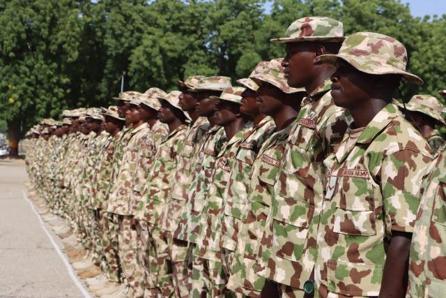 Nigerian Army personnel stand at attention during the vist of Nigeria's Chief of Army Staff (COAS) Lieutenant General Waidi Shaibu to the Headquarters Theatre Command Joint Task Force in Maiduguri, on October 17, 2026. Suspected jihadists believed to be linked to the Islamic State (IS) group killed 15 soldiers and five members of anti-jihadist militias in an attack on a base in Borno State, in northeastern Nigeria, military and local sources said on October 14. "The terrorists killed 15 soldiers and five members of the CJTF militia who were assisting the soldiers in the attack," a Nigerian army officer told AFP. (Photo by Audu MARTE / AFP)