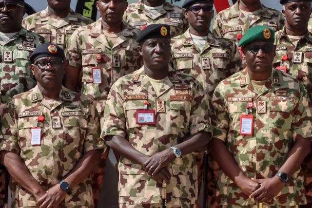 Nigeria's Chief of Army Staff (COAS) Lieutenant General Waidi Shaibu (C) poses for a photograph with military personnel during his visit to the Headquarters Theatre Command Joint Task Force in Maiduguri, on October 17, 2026. Suspected jihadists believed to be linked to the Islamic State (IS) group killed 15 soldiers and five members of anti-jihadist militias in an attack on a base in Borno State, in northeastern Nigeria, military and local sources said on October 14. "The terrorists killed 15 soldiers and five members of the CJTF militia who were assisting the soldiers in the attack," a Nigerian army officer told AFP. (Photo by Audu MARTE / AFP)