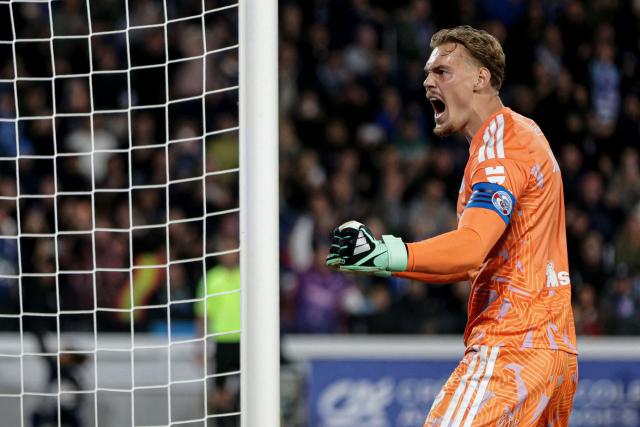 Strasbourg's Danish goalkeeper #01 Filip Jorgensen reacts after stopping a penalty during the French L1 football match between RC Strasbourg Alsace and Paris Saint-Germain (PSG) at the Stade de la Meinau in Strasbourg, eastern France, on October 17, 2026. (Photo by ROMEO BOETZLE / AFP)