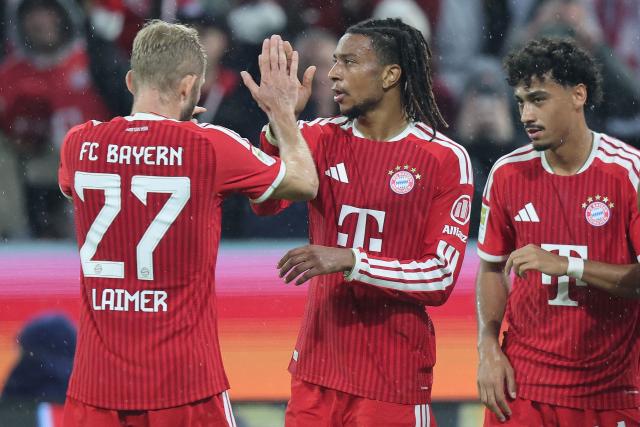 Bayern Munich's French midfielder #17 Michael Olise (C) celebrates scoring the 3-0 goal with his teammates including Bayern Munich's Austrian midfielder #27 Konrad Laimer (L) during the German first division Bundesliga football match between FC Bayern Munich and RB Leipzig in Munich, southern Germany, on October 17, 2026. (Photo by Alexandra BEIER / AFP) / DFL REGULATIONS PROHIBIT ANY USE OF PHOTOGRAPHS AS IMAGE SEQUENCES AND/OR QUASI-VIDEO   ALTERNATIVE CROP