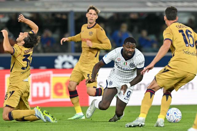 Inter Milan's French forward #9 Marcus Thuram fights for the ball with Bologna's Italian defender #36 Matteo Darmian, and Bologna's Italian defender #16 Nicolo Casale during the Italian Serie A football match between Bologna and Inter Milan at the Renato Dall'Ara stadium in Bologna on October 17, 2026. (Photo by Stefano RELLANDINI / AFP)