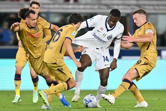 Inter Milan's French forward #14 Ange-Yoan Bonny (C) fights for the ball with Bologna's Belgian defender #03 Arthur Theate (L) and Bologna's Scottish midfielder #19 Lewis Ferguson (R) during the Italian Serie A football match between Bologna and Inter Milan at the Renato Dall'Ara stadium in Bologna on October 17, 2026. (Photo by Stefano RELLANDINI / AFP)