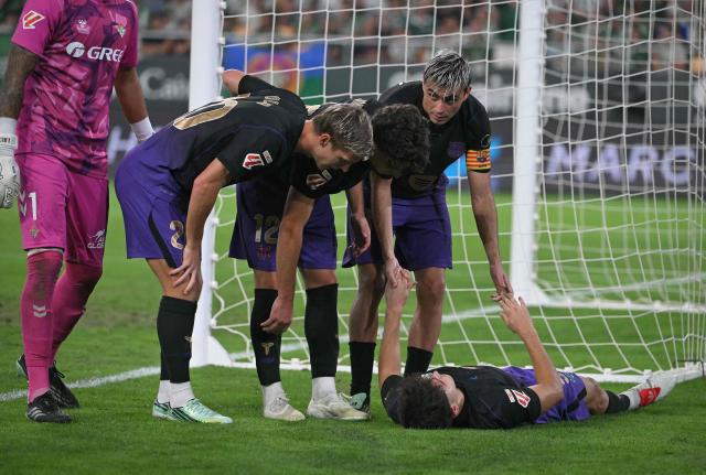 Barcelona's Spanish defender #05 Pau Cubarsi lies on the ground during the Spanish league football match between Real Betis and FC Barcelona at La Cartuja stadium in Seville on October 17, 2026. (Photo by JORGE GUERRERO / AFP)