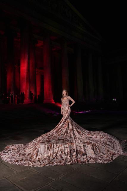 The Bayeux Tapestry is displayed on a dress modelled on the red carpet at The British Museum Ball 2026 in London on October 17, 2026. (Photo by CARLOS JASSO / AFP)