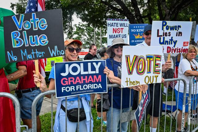 People take part in a "No Kings: Vote Early" demonstration in Wilton Manors, Florida, on October 17, 2026. The national day of action is taking place in cities across the country focusing on voter turnout, early voting and election protection, ahead of the midterm elections. (Photo by Giorgio VIERA / AFP)