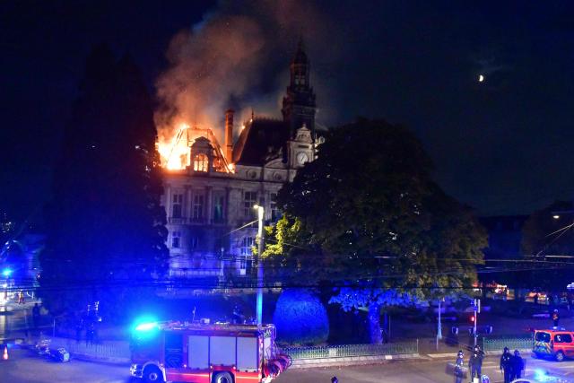 This photograph shows a fire burning at the city hall after a group of individuals forced entry into the building during ongoing protest action against the "high cost of living", in Limoges, central France on October 17, 2026 as part of a nationwide call for mobilisation bringing together various groups expressing their anger: former "Yellow Vest", secondary school and university students, climate activists and even farmers. After weeks of student protests, France faces broader, nationwide demonstrations on October 17, 2026 over the cost of living, setting up a potentially fraught six months heading into a presidential election. A police source told AFP that authorities estimated nearly 200,000 people could take part, with 40,000 in Paris. (Photo by Pascal LACHENAUD / AFP)