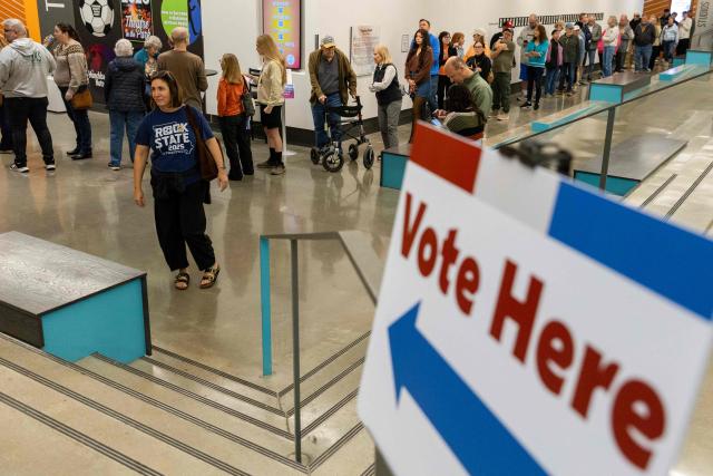 People arrive to vote during first day of early voting at the Johnson County Arts And Heritage Center in Overland Park, Kansas City, Kansas, October 17, 2026. Americans voting in the November 3 midterm elections will decide who controls Congress for the final two years of Donald Trump's presidency, along with dozens of governorships and thousands of state offices. (Photo by Austin Johnson / AFP)