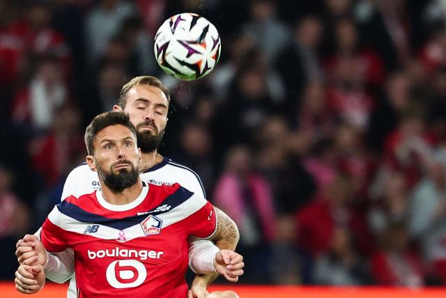 Lille's French forward #09 Olivier Giroud goes for a header with Brest's Senegalese forward #09 Pathe Mboup during the French L1 football match between Lille LOSC and Stade Brestois 29 (Brest) at the Stade Pierre-Mauroy in Villeneuve-d'Ascq, northern France, on October 17, 2026. (Photo by Sameer AL-DOUMY / AFP)