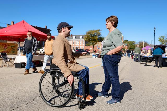 Democratic US Senate Candidate Josh Turek speaks to a member of the public during a campaign stop at the Dubuque Farmers Market in Dubuque, Iowa, on October 17, 2026. Turek is running to replace the retiring US Senator Joni Ernst. Americans voting in the November 3 midterm elections will decide who controls Congress for the final two years of Donald Trump's presidency, along with dozens of governorships and thousands of state offices. (Photo by KAMIL KRZACZYNSKI / AFP)