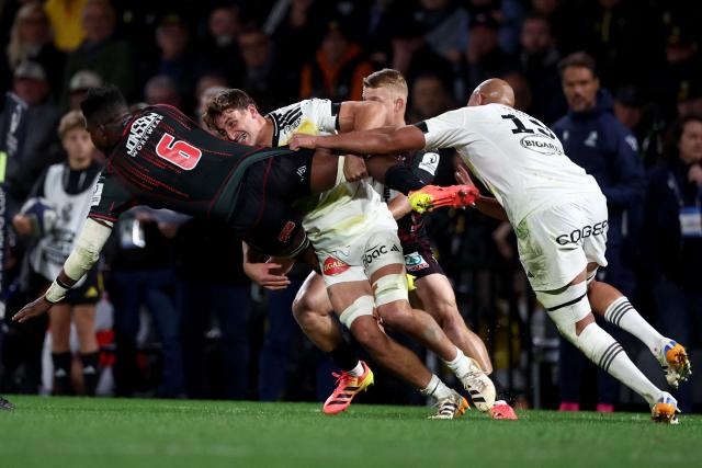 Lions' South African lock Siba Mahashe (L) is tackled by La Rochelle's French flanker Oscar Jegou (C) during the European Rugby Champions Cup rugby union match between Stade Rochelais (La Rochelle) and Lions at at the Marcel-Deflandre Stadium in La Rochelle, western France, on October 17, 2026. (Photo by ROMAIN PERROCHEAU / AFP)