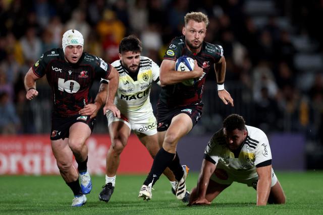 Lions' South African winger Richard Kriel (2R) runs with the ball during the European Rugby Champions Cup rugby union match between Stade Rochelais (La Rochelle) and Lions at at the Marcel-Deflandre Stadium in La Rochelle, western France, on October 17, 2026. (Photo by ROMAIN PERROCHEAU / AFP)