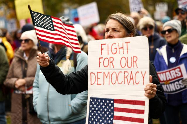 People take part in a "No Kings: Vote Early" demonstration in Portland, Maine on October 17, 2026. The national day of action is taking place in cities across the country focusing on voter turnout, early voting and election protection, ahead of the midterm elections. (Photo by CHARLY TRIBALLEAU / AFP)