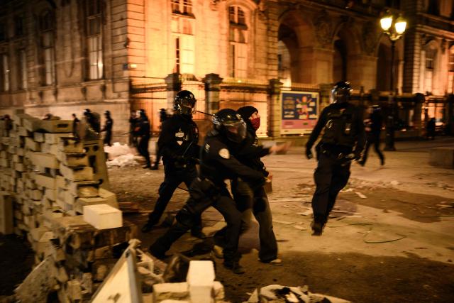 Police officers push a demonstrator place de la Comedie during ongoing protest action against the "high cost of living", in Lyon, southeastern France, on October 17, 2026 as part of a nationwide call for mobilisation bringing together various groups expressing their anger: former "Yellow Vests", secondary school and university students, climate activists and even farmers. After weeks of student protests, France faces broader, nationwide demonstrations on October 17, 2026 over the cost of living, setting up a potentially fraught six months heading into a presidential election. A police source told AFP that authorities estimated nearly 200,000 people could take part, with 40,000 in Paris. (Photo by JEFF PACHOUD / AFP)