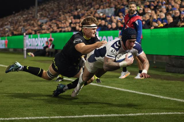 Montpellier's Scottish full-back Stuart Hogg dives over the line to score the opening try during the European Rugby Champions Cup pool 4 match between Bath and Montpellier at The Rec in Bath, south-west England on October 17, 2026. (Photo by Adrian DENNIS / AFP)
