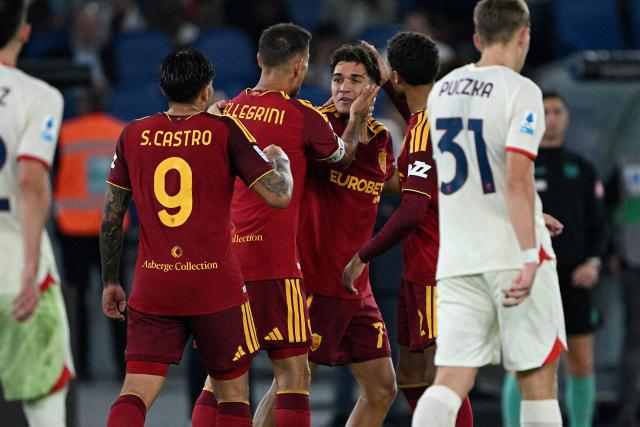 AS Roma's Italian defender #77 Emanuele Lulli (C) celebrates with teammates after scoring a goal during the Italian Serie A football match between AS Roma and Genoa at the Olympic Stadium in Rome on October 17, 2026. (Photo by Andreas SOLARO / AFP)