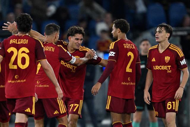 AS Roma's Italian defender #77 Emanuele Lulli (C) celebrates with teammates after scoring a goal during the Italian Serie A football match between AS Roma and Genoa at the Olympic Stadium in Rome on October 17, 2026. (Photo by Andreas SOLARO / AFP)