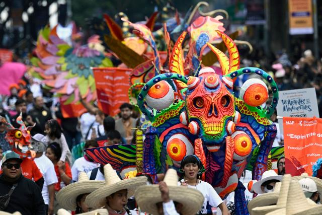 An alebrije sculpture is displayed during the Alebrijes Parade ahead of Day of the Dead celebrations in Mexico City on October 17, 2026. The Alebrijes Parade is an annual event celebrating Mexican folk art and handicrafts, during which giant mythical creatures made of "cartoneria" (a form of papier-mache) are paraded from Mexico City's Zocalo through the capital's main avenues to the Angel of Independence, where they remain on display. (Photo by Alfredo ESTRELLA / AFP)