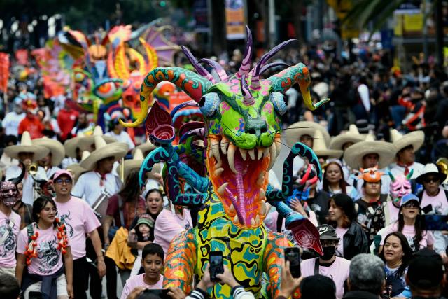 An alebrije sculpture is displayed during the Alebrijes Parade ahead of Day of the Dead celebrations in Mexico City on October 17, 2026. The Alebrijes Parade is an annual event celebrating Mexican folk art and handicrafts, during which giant mythical creatures made of "cartoneria" (a form of papier-mache) are paraded from Mexico City's Zocalo through the capital's main avenues to the Angel of Independence, where they remain on display. (Photo by Alfredo ESTRELLA / AFP)
