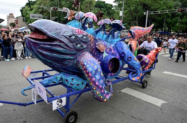 An alebrije sculpture is displayed during the Alebrijes Parade ahead of Day of the Dead celebrations in Mexico City on October 17, 2026. The Alebrijes Parade is an annual event celebrating Mexican folk art and handicrafts, during which giant mythical creatures made of "cartoneria" (a form of papier-mache) are paraded from Mexico City's Zocalo through the capital's main avenues to the Angel of Independence, where they remain on display. (Photo by Alfredo ESTRELLA / AFP)