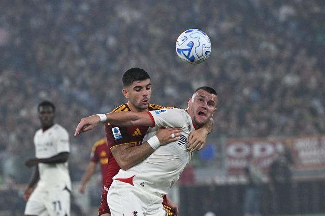 Genoa's Montenegrin forward #18 Milutin Osmajic (R) fights for the ball with AS Roma's Greek defender #03 Konstantinos Koulierakis during the Italian Serie A football match between AS Roma and Genoa at the Olympic Stadium in Rome on October 17, 2026. (Photo by Andreas SOLARO / AFP)