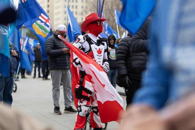 A protestor in a Canada themed outfit attends an Alberta Independence Rally in Edmonton, Alberta, Canada on October 17, 2026. Alberta voters decide next week if they want the oil-rich province to begin the process of separating from Canada, a pivotal test for the country as it confronts a hostile United States. (Photo by Megan Albu / AFP)