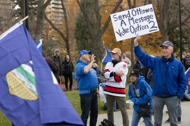 A man holds up a sign during an Alberta Independence Rally in Edmonton, Alberta, Canada on October 17, 2026. Alberta voters decide next week if they want the oil-rich province to begin the process of separating from Canada, a pivotal test for the country as it confronts a hostile United States. (Photo by Megan Albu / AFP)