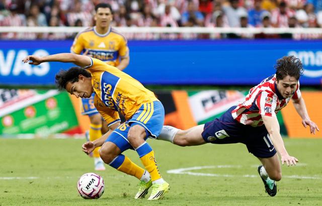 Tigres' midfielder #16 Diego Lainez and Guadalajara's midfielder #11 Brian Gutierrez fight for the ball during the Liga MX Apertura tournament football match between Guadalajara and Tigres at Akron stadium in Zapopan, Jalisco state, Mexico on October 17, 2026. (Photo by ULISES RUIZ / AFP)
