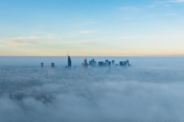 This aerial photograph taken on October 18, 2026 shows Warsaw's skyscrapers shrouded in a blanket of fog on an autumn morning. (Photo by Sergei GAPON / AFP)