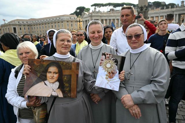 Nuns wait in St Peter's Square before the Angelus prayer, a day after Pope Leo XIV returns to the Vatican following surgery to remove a cancerous tumour from his right lung, on October 18, 2026. (Photo by Andreas SOLARO / AFP)