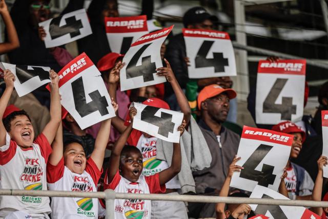 TOPSHOT - Young cricket supporters celebrate after South Africa's Aiden Markram made four runs on day one of the second Test match between South Africa and Australia at St Georges Park in Gqeberha on October 18, 2026. (Photo by Marco Longari / AFP)