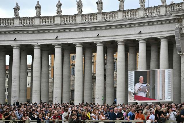 People listen to Pope Leo XIV in St. Peter's square during the Angelus prayer, a day after his return to The Vatican following a surgery to remove a cancerous tumour in his right lung, on October 18, 2026. (Photo by Tiziana FABI / AFP)