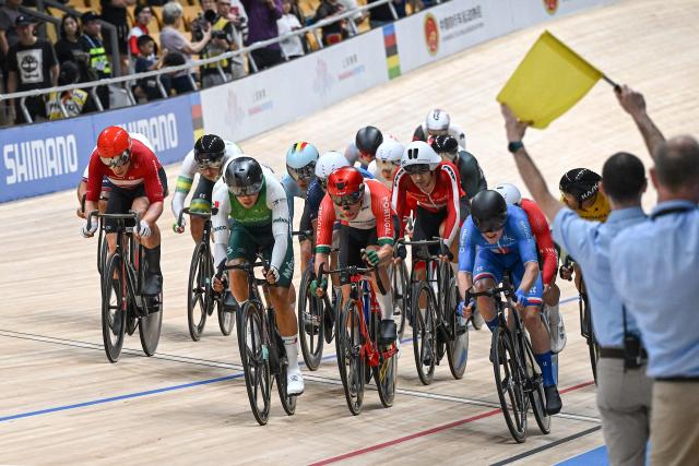 A yellow flag is seen as athletes compete in the men’s elimination race at the 2026 UCI Track World Championships at the Shanghai Velodrome in Shanghai on October 18, 2026. (Photo by JADE GAO / AFP)