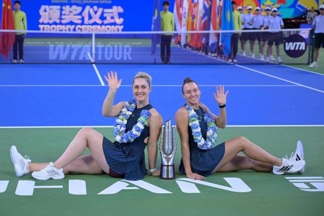 Brazil’s Luisa Stefani (R) and Canada’s Gabriela Dabrowski celebrate with the trophy after beating Czech Republic’s Katerina Siniakova and Australia's Storm Hunter in the women’s doubles final match at the Wuhan Open tennis tournament in Wuhan, China's Hubei province on October 18, 2026. (Photo by WANG Zhao / AFP)